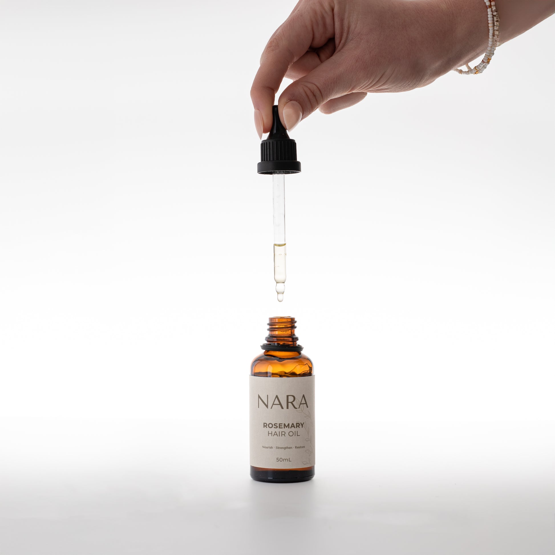 natural skincare NZ rosemary hair oil for hair growth in eco-friendly packaging